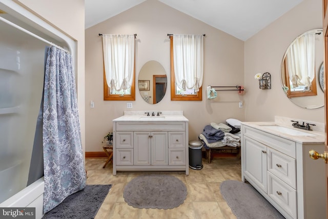 bathroom with tile flooring, vaulted ceiling, shower / bath combination with curtain, and double vanity