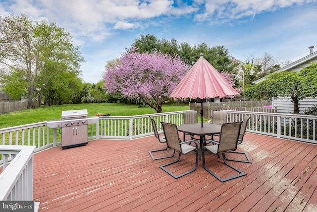 deck with grilling area and a lawn