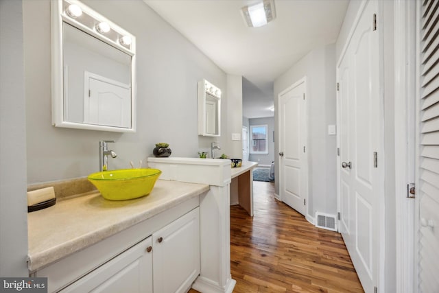 bathroom featuring vanity and hardwood / wood-style flooring