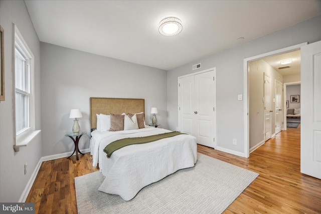 bedroom with a closet and hardwood / wood-style flooring