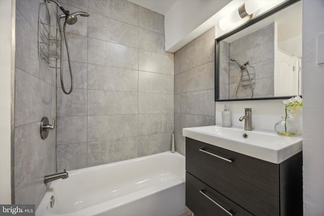 bathroom with vanity and tiled shower / bath combo