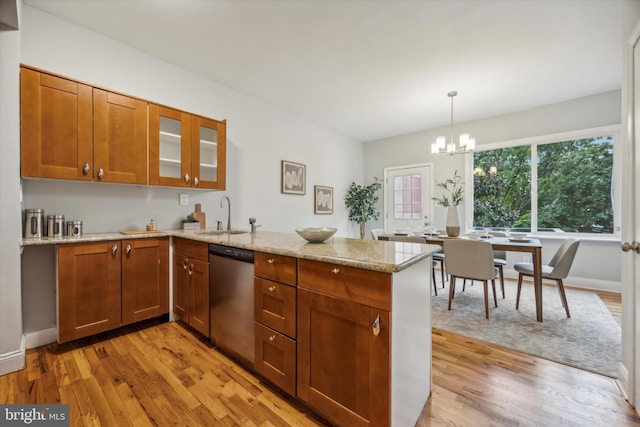 kitchen featuring dishwasher, kitchen peninsula, and light hardwood / wood-style floors