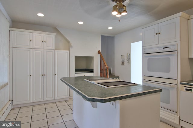 kitchen featuring a kitchen island, white cabinets, ceiling fan, and white appliances