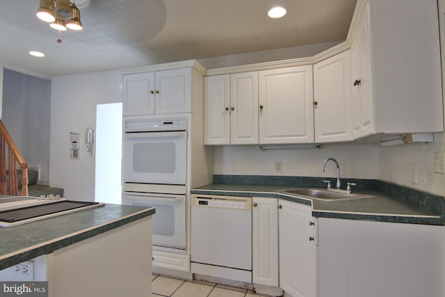 kitchen featuring ceiling fan, sink, white appliances, light tile flooring, and white cabinetry