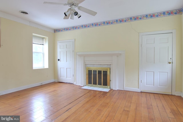 unfurnished living room with ceiling fan and light wood-type flooring