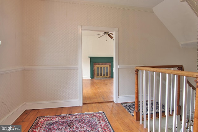 corridor featuring light hardwood / wood-style flooring and vaulted ceiling