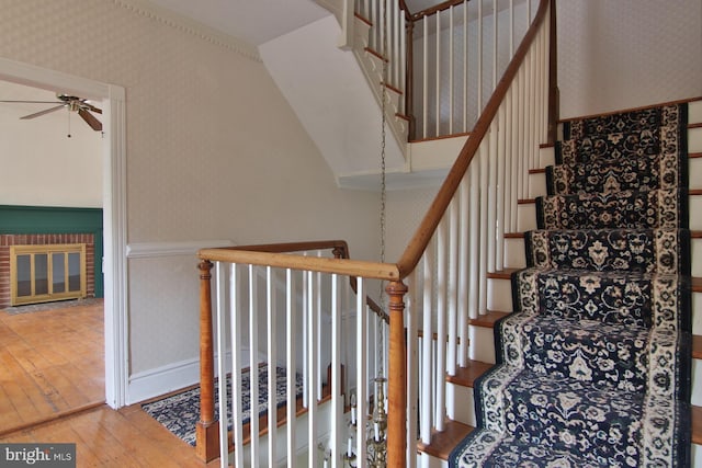 stairway featuring light hardwood / wood-style floors and ceiling fan