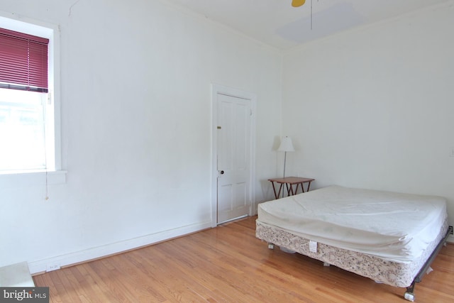 bedroom with ceiling fan and light hardwood / wood-style floors