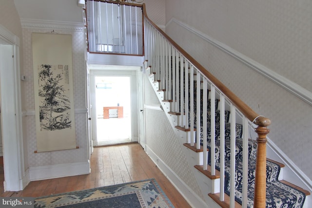 entrance foyer with light hardwood / wood-style floors and ornamental molding