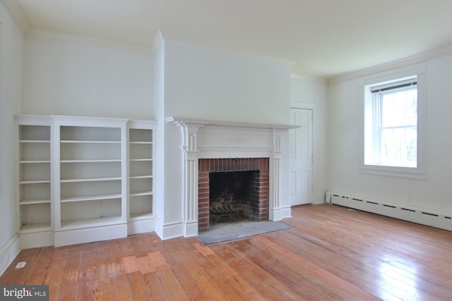 unfurnished living room featuring crown molding, a fireplace, a baseboard radiator, and light wood-type flooring