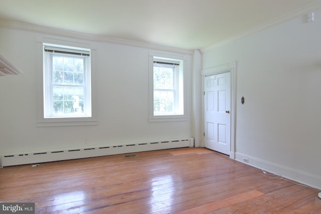 unfurnished room featuring light hardwood / wood-style floors, crown molding, and baseboard heating