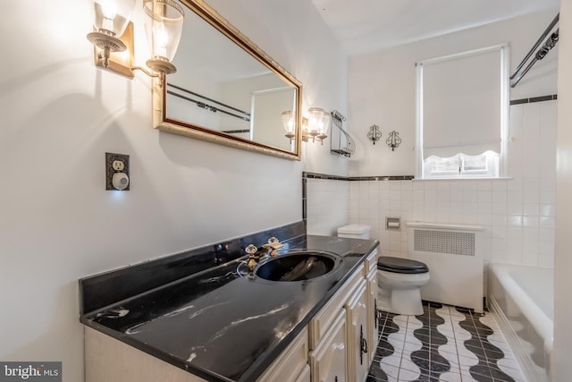 full bathroom featuring tile walls, toilet, tile flooring, radiator heating unit, and vanity