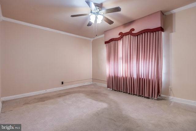 carpeted spare room featuring ornamental molding and ceiling fan