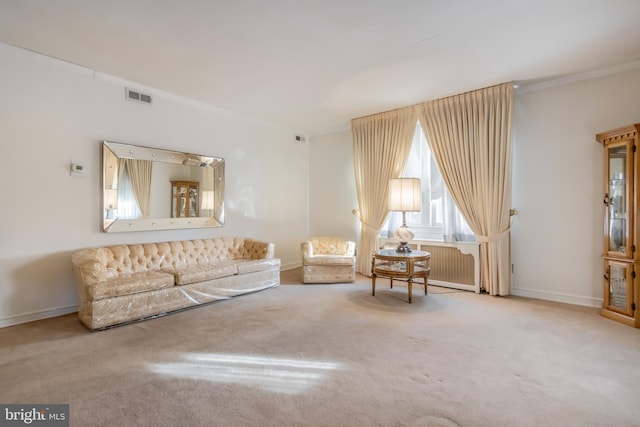 living area with light colored carpet and crown molding