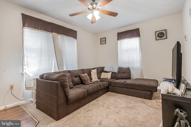 living room featuring ceiling fan and light hardwood / wood-style flooring