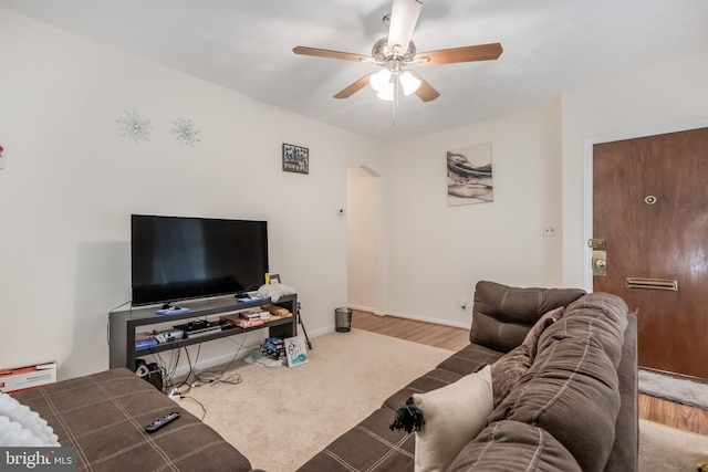 living room featuring light colored carpet and ceiling fan