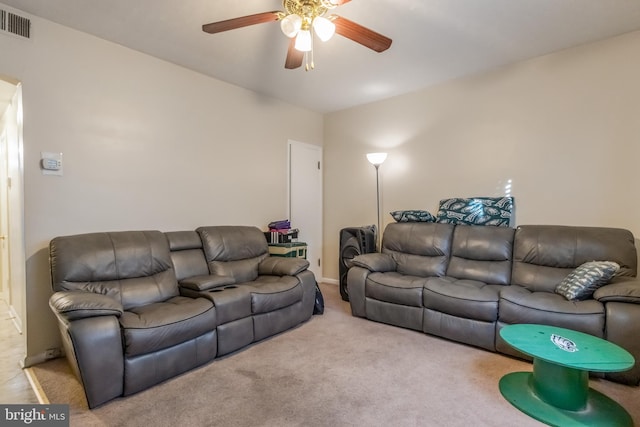 carpeted living room featuring ceiling fan