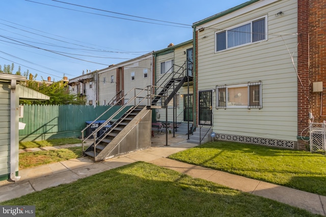 rear view of property with a lawn