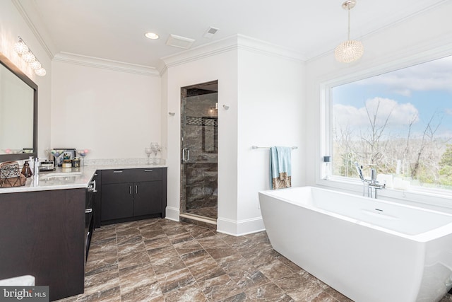 bathroom featuring ornamental molding, a freestanding bath, vanity, and a shower stall