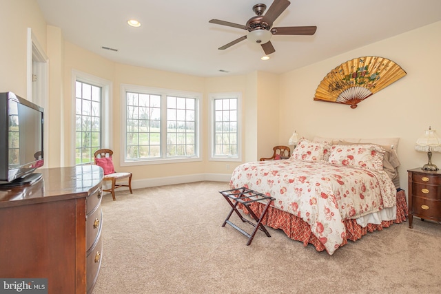 carpeted bedroom featuring recessed lighting, visible vents, baseboards, and multiple windows