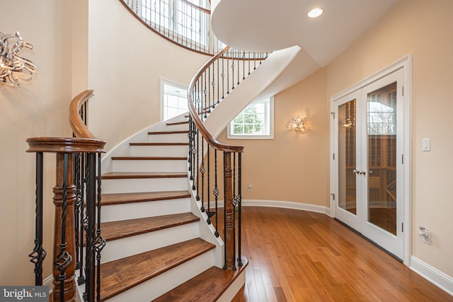 entryway featuring french doors, recessed lighting, hardwood / wood-style floors, baseboards, and stairs