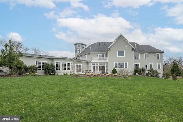 rear view of property with a lawn