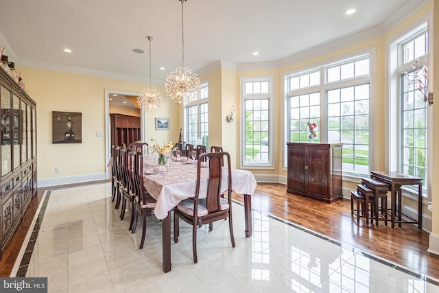 dining area with ornamental molding, recessed lighting, an inviting chandelier, and baseboards