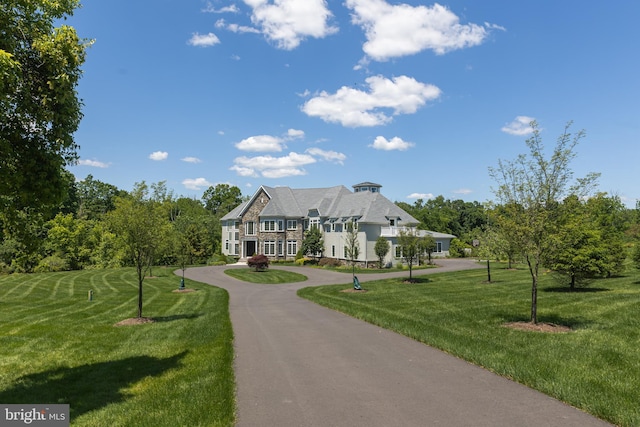 view of front of property with driveway and a front lawn