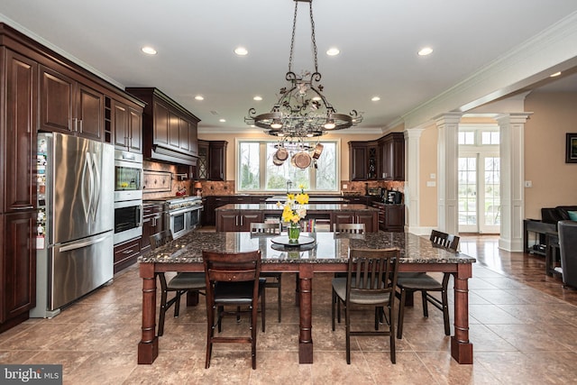 dining room featuring crown molding, a notable chandelier, decorative columns, recessed lighting, and light tile patterned flooring