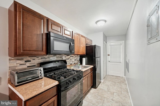 kitchen featuring black appliances, decorative backsplash, and sink