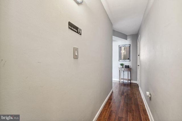 hallway with dark hardwood / wood-style flooring