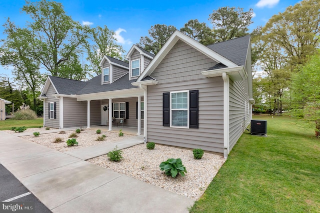 view of front of house featuring central AC, covered porch, and a front yard