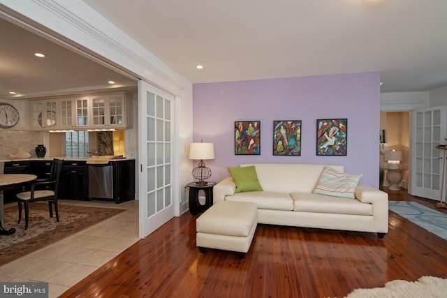 tiled living room featuring french doors