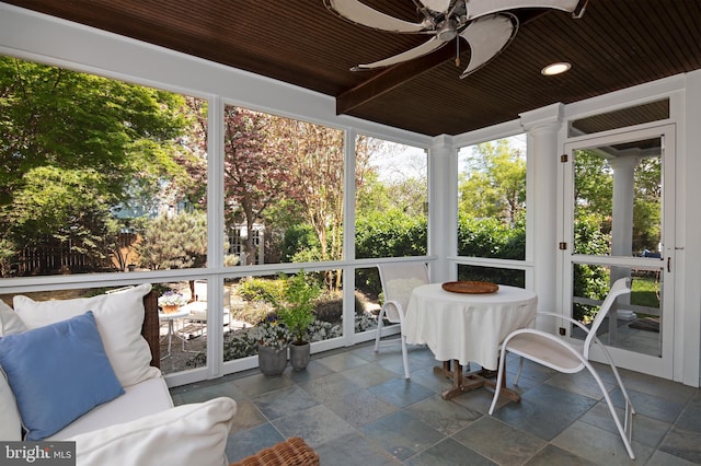 sunroom with wood ceiling and ceiling fan