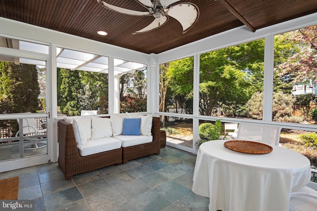 unfurnished sunroom featuring wooden ceiling and ceiling fan