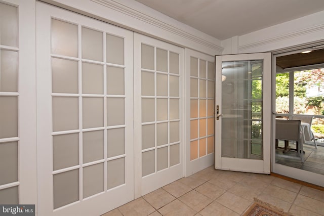 doorway featuring french doors and light tile flooring