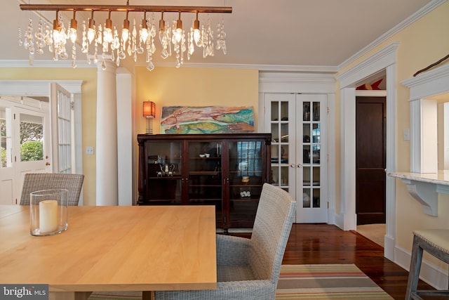 dining room featuring ornamental molding, a notable chandelier, french doors, and dark hardwood / wood-style flooring