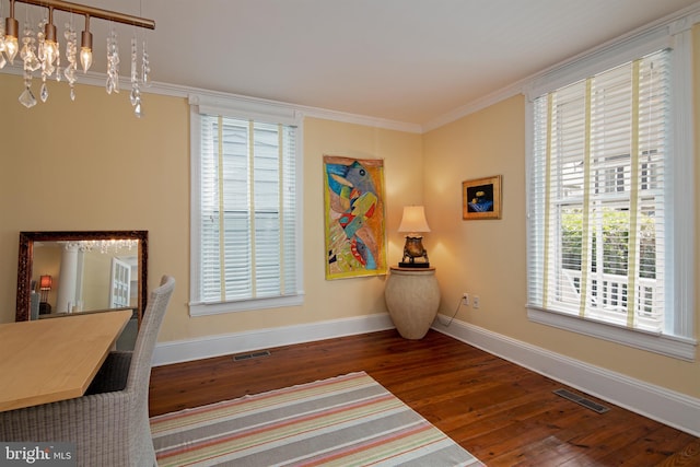 home office featuring ornamental molding, a chandelier, and dark wood-type flooring