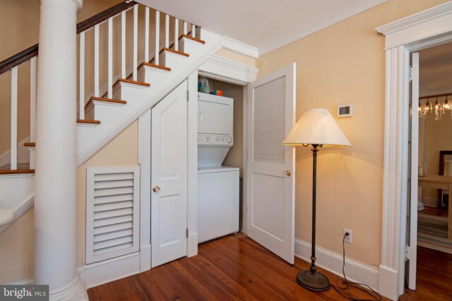 stairway featuring crown molding, dark hardwood / wood-style flooring, and stacked washer and dryer