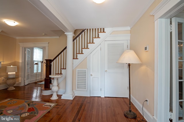 interior space with ornamental molding, ornate columns, and dark wood-type flooring