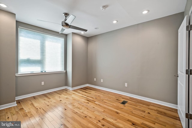 empty room with ceiling fan and light wood-type flooring