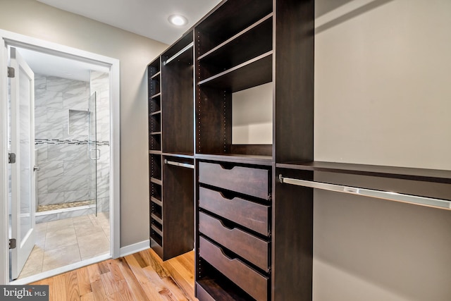 spacious closet with light tile flooring