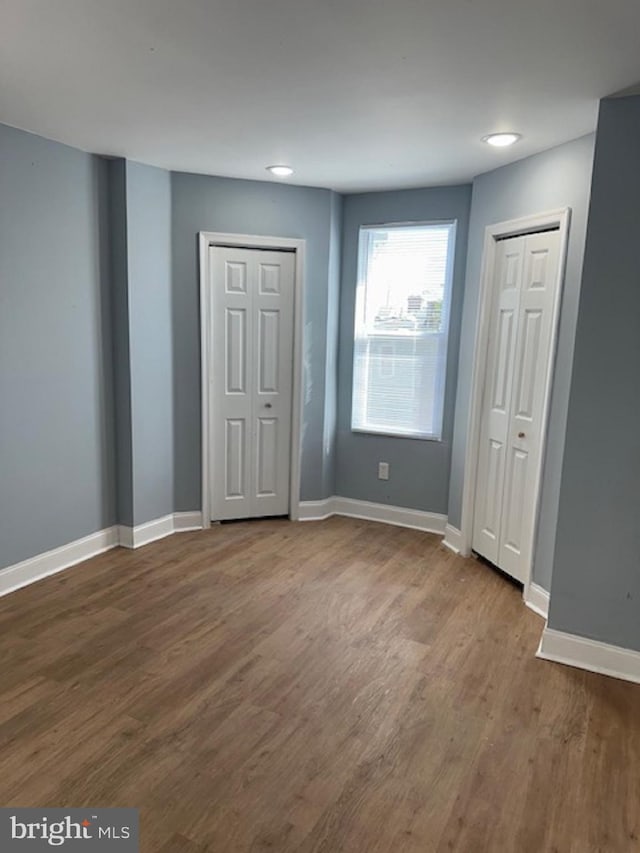 unfurnished room with dark wood-type flooring