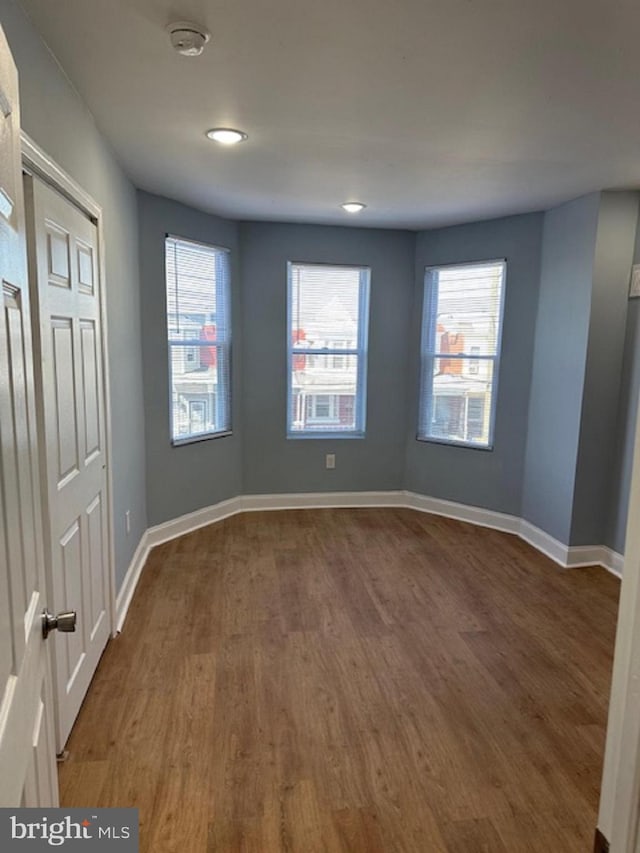 spare room with dark hardwood / wood-style flooring