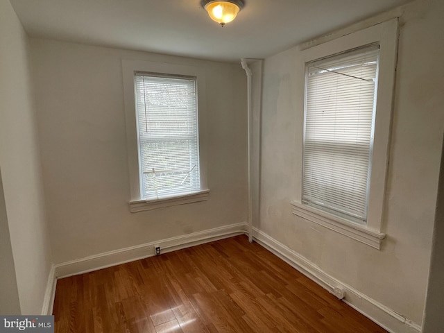 spare room featuring dark wood-type flooring