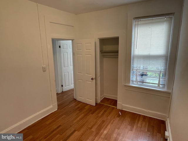 unfurnished bedroom featuring a closet and light wood-type flooring