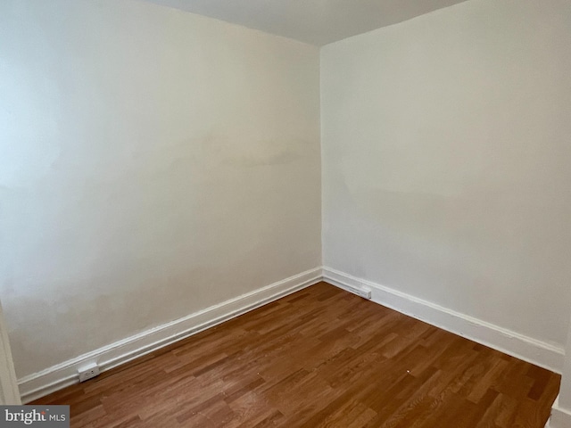 empty room with dark wood-type flooring