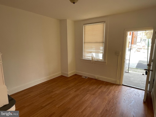 spare room featuring dark hardwood / wood-style floors