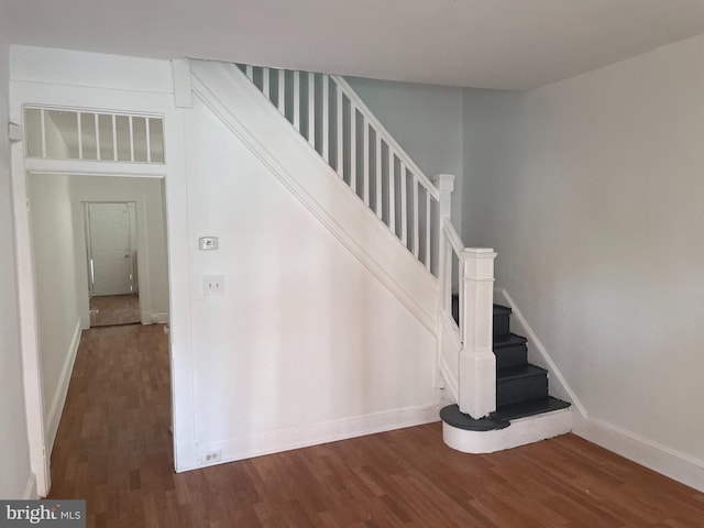 stairs featuring dark wood-type flooring