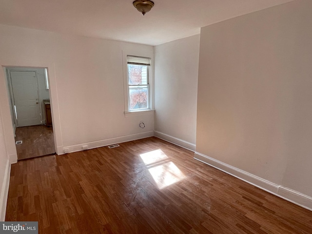 spare room featuring dark hardwood / wood-style flooring